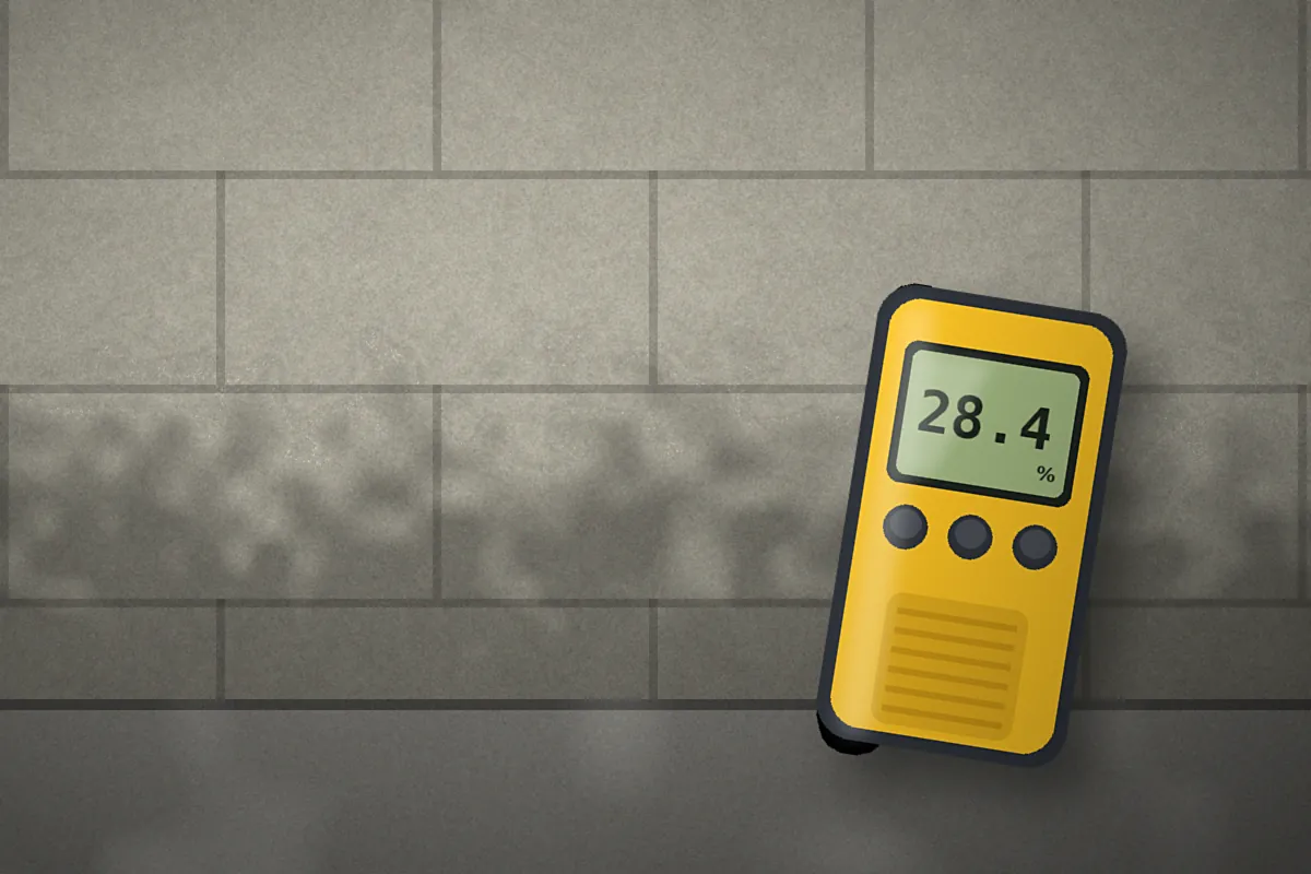Handheld moisture meter reading 28.4 percent against a concrete block basement wall with damp staining near the floor